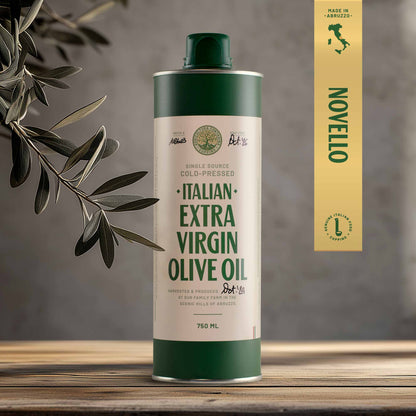 A 750ml bottle of Italian Extra Virgin Olive Oil with a green cap, placed on a wooden surface with an olive branch in the background.