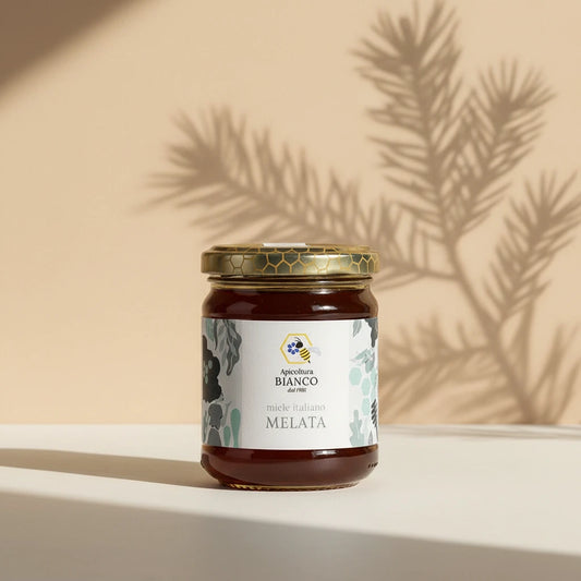 Jar of honeydew honey with a decorative label on a artistic background